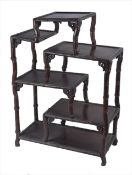 A large Chinese simulated bamboo hardwood display stand, of asymmetrical design, 107cm high, 77cm