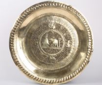 An early 20th century Indian large brass tray, decorated with a central roundel of an elephant
