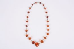 An amber bead necklace, possibly English, late 19th century with graduated faceted beads on gilt