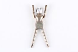 An unusual pair of silver and enamel sugar tongs in the form of a ‘Dutch dolly’, by Cohen and