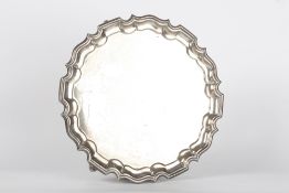 A silver salver, hallmarked Sheffield, 1926 with initials for T. Bradbury & Sons, with pie crust