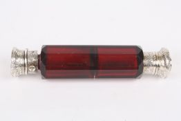 A Victorian double ended perfume bottle, the faceted cranberry coloured glass bottle with silver