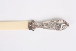 A Victorian silver and carved ivory page turner, hallmarked Birmingham 1891, the handle embossed