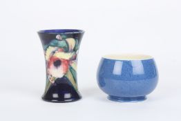 A small Moorcroft ‘Orchid’ vase, of cylindrical form, the flowers painted in pinks, purples and