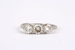 A platinum and diamond three stone ring, with double claw setting and plain shank. Size M ½ . No