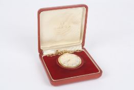 An 18ct yellow gold Omega dress pocket watch on chain, the watch with silvered dial and baton