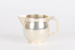 A George V globular silver cream jughallmarked Birmingham 1912, of plain form with sparrow beak