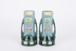 A pair of Secessionist vases in the manner of Mintonthe blue ground bodies decorated with scarab