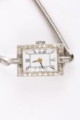 A ladies Art deco style diamond cocktail watchthe white rectangular shaped dial surrounded by small
