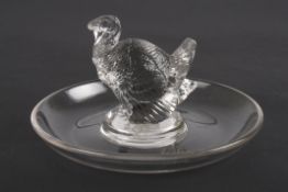 An R. Lalique clear glass ring dishmounted with a model of a turkey. Etched signature to base 'R.