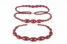 Two cherry amber coloured necklacesthe first single strand graduated oblong beads on modern