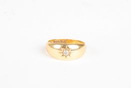 An 18ct gold and diamond gentlemans ringset with central diamond weighing approx 5pts, 4.2 grams.