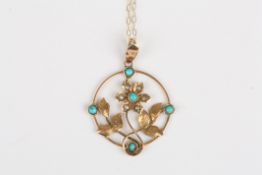 An Edwardian 9ct gold, seed pearl and turquoise pendantformed as a flower head with leaves in a