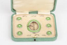 An Edwardian silver and enamel buckle and button sethallmarked Birmingham 1910, the oval buckle and