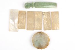 A Chinese carved jade pendantdecorated with a mouse on either side, together with a green jade