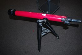 A Tasco telescope on tripod base.