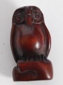 A wooden carved Netsuke of a an Owl