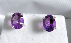 A pair of silver and amethyst earrings