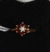 A 9ct gold 375 ruby and opal ring. The c
