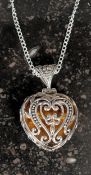 A silver heart shaped necklace set with