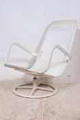 A retro 1970's swivel chair raised on ci