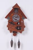 A contemporary cuckoo clock having centr