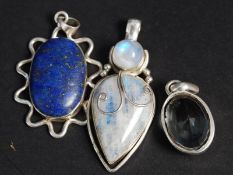A collection of £ silver pendants with i
