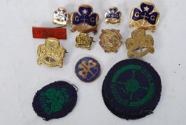 A collection of girl guide enamel badges