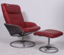 A contemporary red leather reclining and