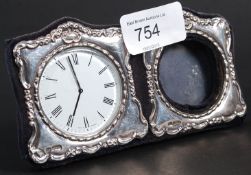 A silver hallmarked clock an picture fra