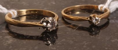 Two 18k gold single stone diamond rings.