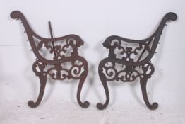 A pair of cast iron bench ends having li