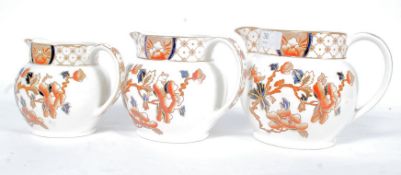 A set of 3 Imari pattern graduating jugs