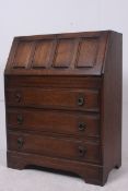 A Jacobean revival oak bureau having che