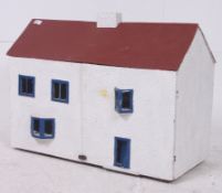 A 20th century dollhouse with red roof h