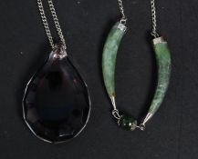 2 silver and jade tooth shaped pendants