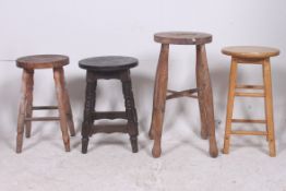A collection of 4 wooden stools to inclu