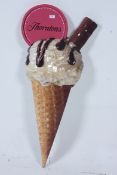 A large retro ice cream cone shop advert