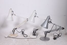 A collection of three anglepoise lamps