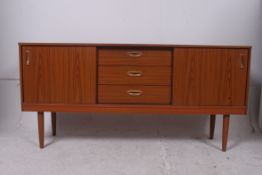 A 1970's teak effect low sideboard dress