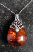 A large silver pearl and amber style pendant necklace on white metal chain