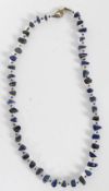 A Lapis Lazuli beaded necklace having 44 stones, each being divided by smaller stones