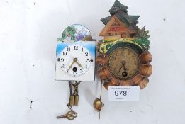 2 miniature Black Forest wall clocks one with porcelain face.
