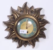 An early 20th century sunburst French gilt metal wall clock by Silvoz of Paris.  Blue chapter ring