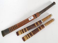 A mid 20th century Burmese short sword having brass handle with steel blade and wooden scabbard.