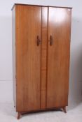 A 1950's walnut twin door single wardrobe by Wrighton Furniture. Raised on angular feet with twin