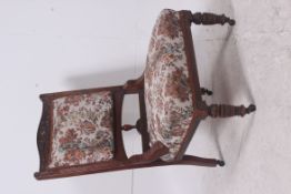 A Victorian mahogany tapestry upholstered ladies armchair / nursing chair. The turned legs with