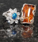 A silver and amber style ring together with another flower shaped ring set with CZstamped 925.