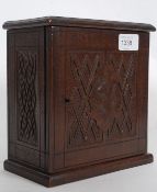 A Victorian carved walnut apprentice piece cabinet. The cabinet raised on plinth base having