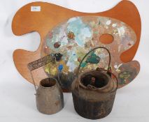 An artists smelting together with 2 palettes, one unused and another lead paint mixing pot.